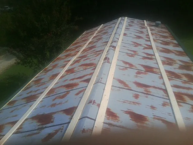 Rusted metal roof panels with new wood purlins before replacement — Storm Damage Roof Repair in Canal Winchester by Roofing Brothers
