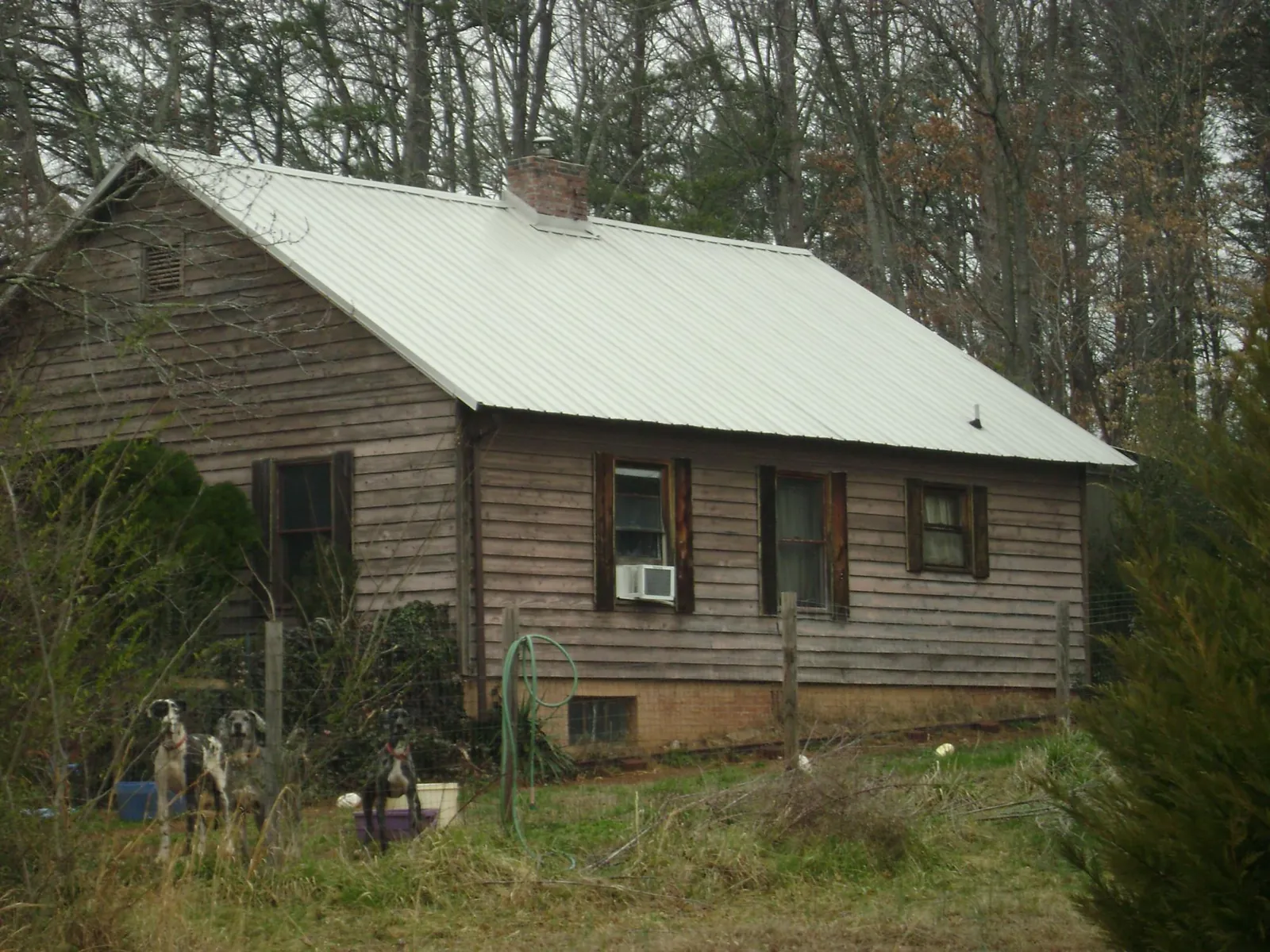 White metal roof on an old wood sided farmhouse, from a Metal Roof Installation job in Canal Winchester